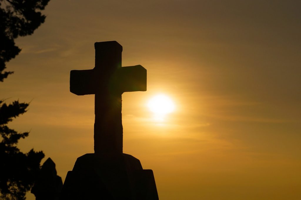 stone cross at sunset